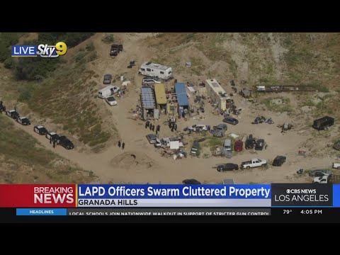 LAPD officers swarm cluttered property